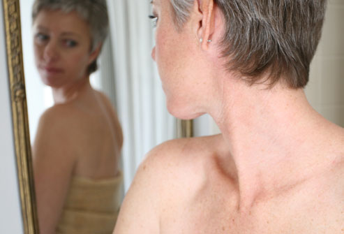 woman looking in mirror